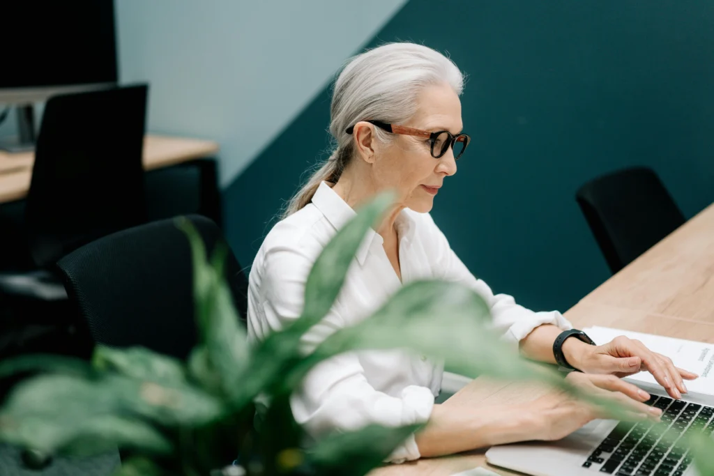 Older woman learning new skills as a volunteer coordinator