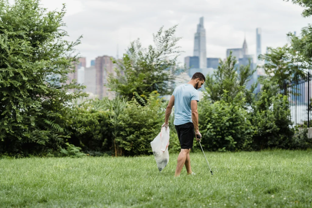 Volunteer picking up trash in a park