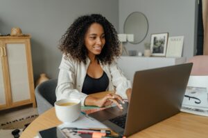 woman smiling at her laptop