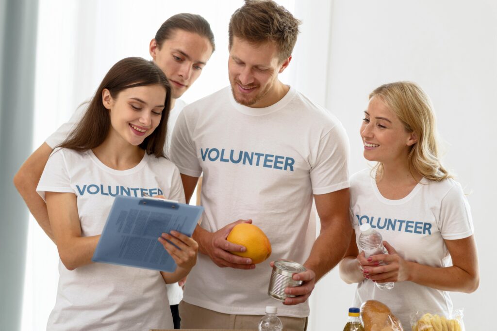 A group of volunteers looking at a clipboard together.