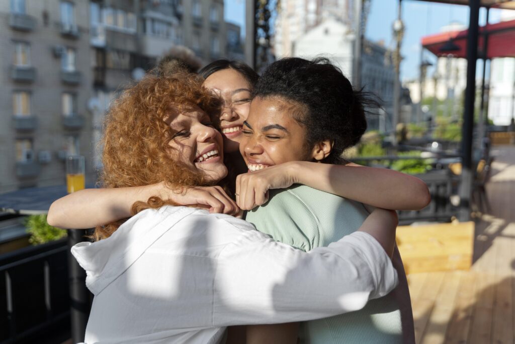 Three women hugging each other.