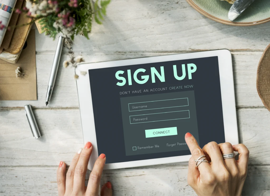 A mobile tablet with a sign up account login form displayed on the screen.