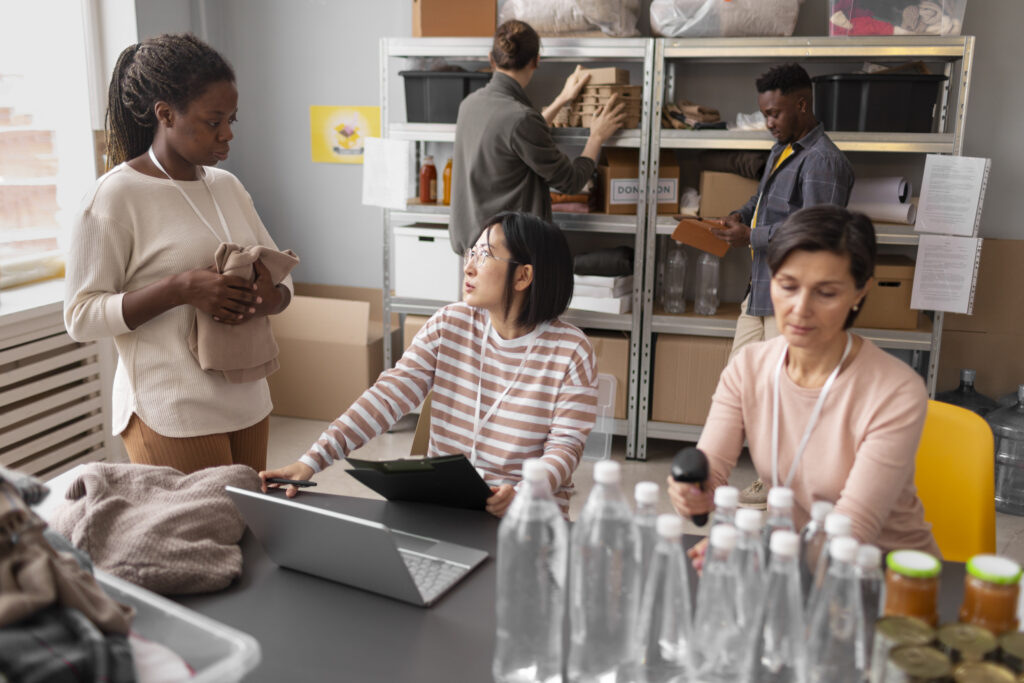A group of volunteers and a staff volunteer coordinator doing various tasks together.